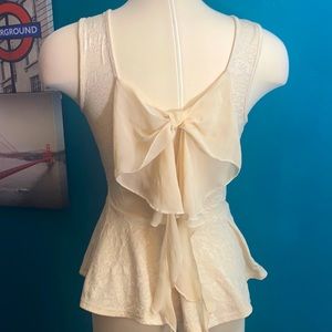 Cream colored peplum bow top